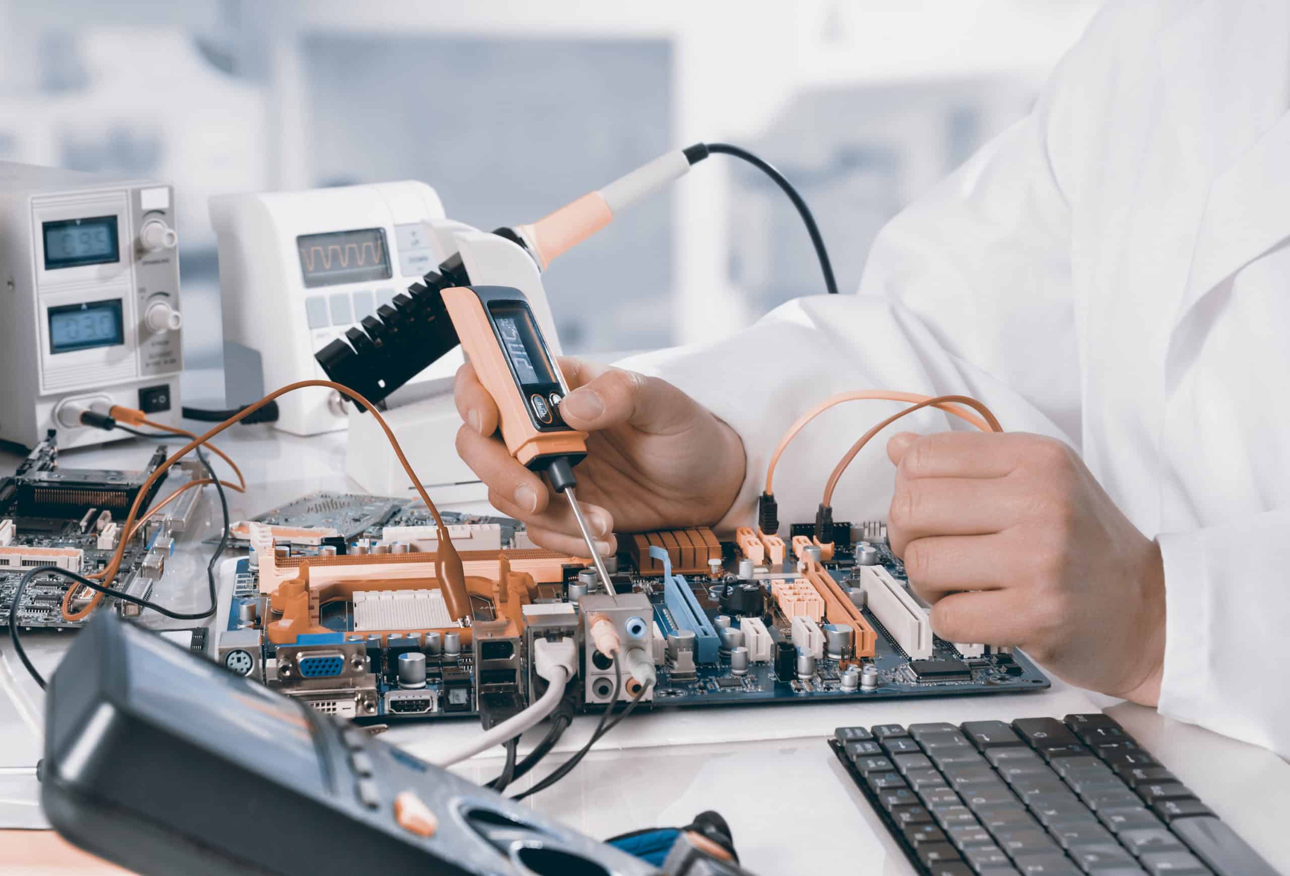 Repairman fixes electronic equipment in service center